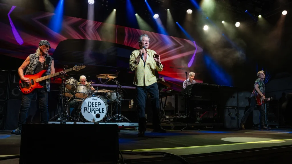 Deep Purple performing live, with Ian Gillan at the microphone and the band's logo on the drum kit
