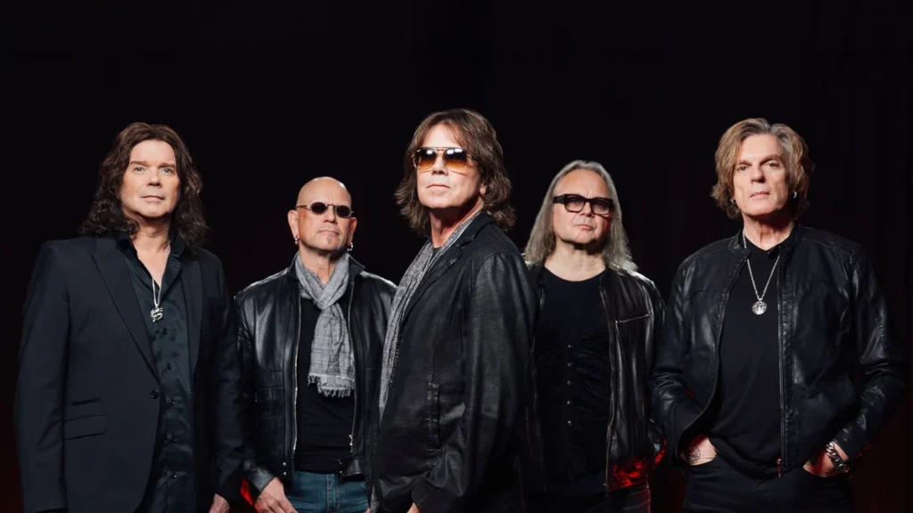 Europe, left to right John Norum, Ian Haugland, Joey Tempest, Mic Michaeli and John Levén, posed against a dark curtain