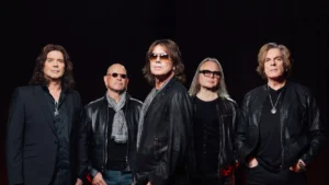 Europe, left to right John Norum, Ian Haugland, Joey Tempest, Mic Michaeli and John Levén, posed against a dark curtain
